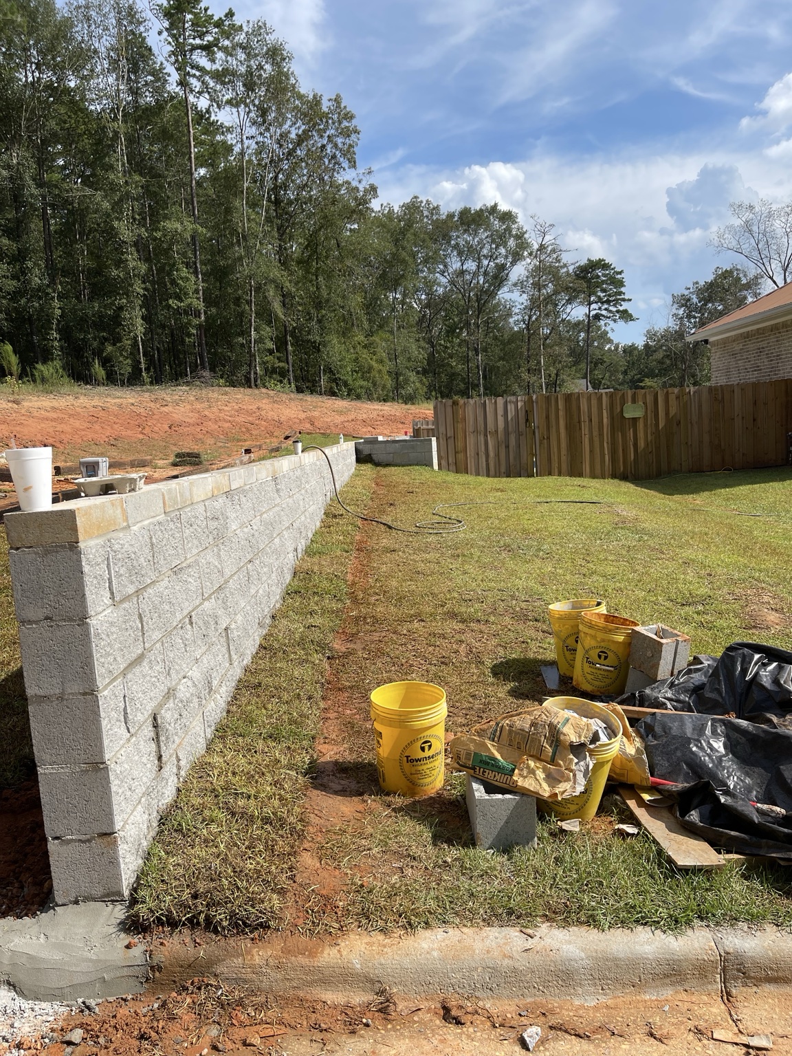 Concrete block retaining wall construction